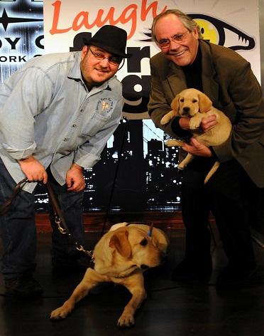 Brian Fischler with his guide dog Nash and That Real Blind Tech show guest Legendary Comedian Robert Klein who is holding two Guiding Eyes for the Blind puppies at Laugh For Sight NYC